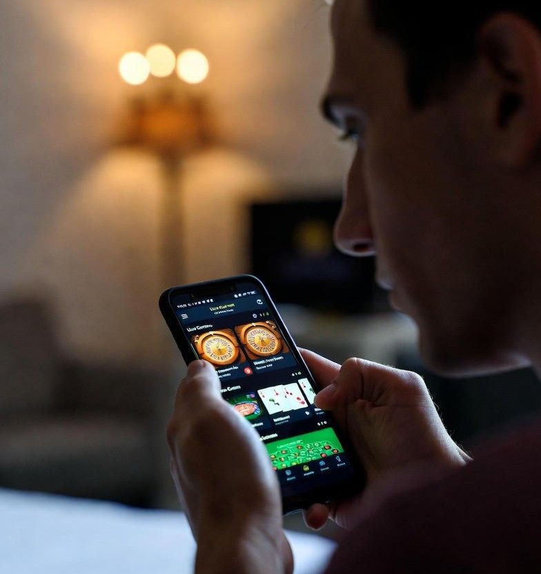 player using a smartphone to access live casino games