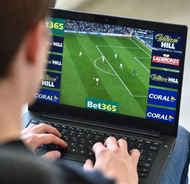 watching a live football match on a laptop